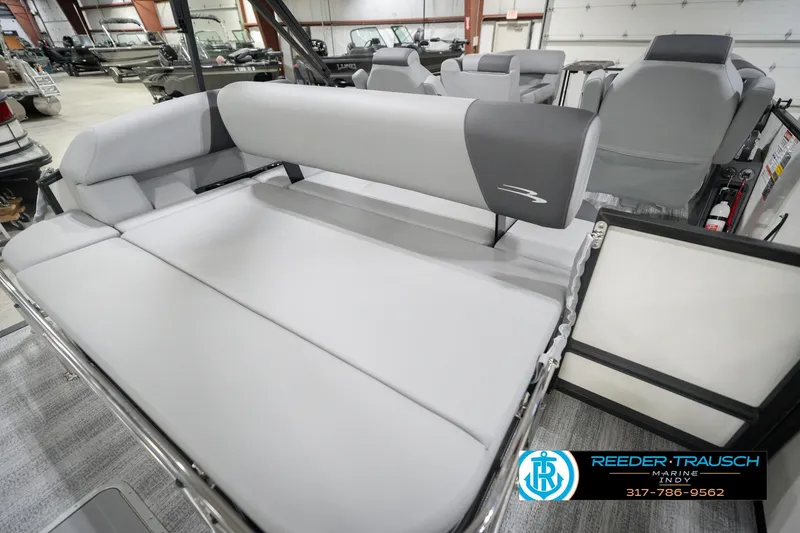 Slide: The Image of 2026 Bennington 22 SSB pontoon boat interior with gray seating in showroom. - 29