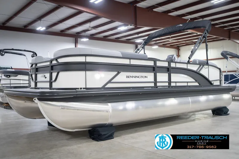 Slide: The Image of 2026 Bennington 22 SSB pontoon boat in showroom, featuring sleek design and modern amenities. - 3