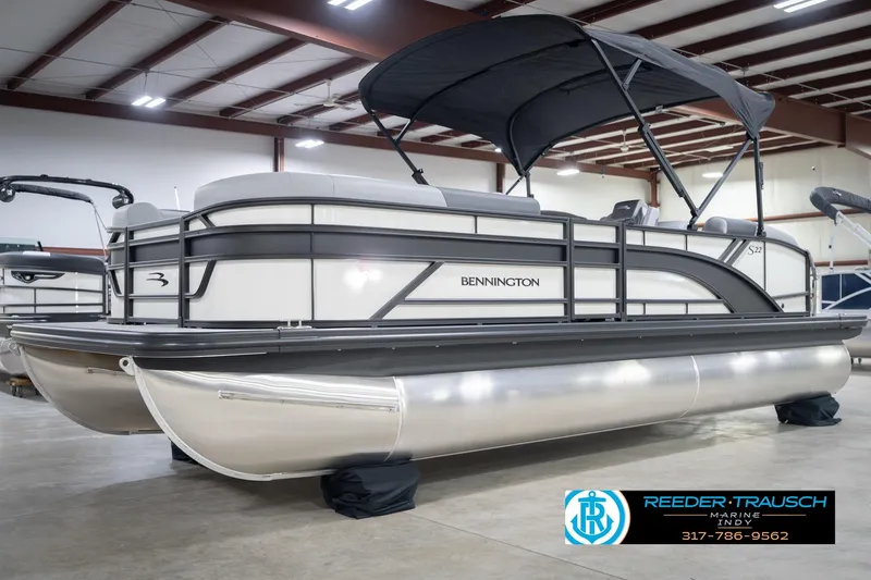 Slide: The Image of 2026 Bennington 22 SSB pontoon boat in showroom with canopy and sleek design. - 4