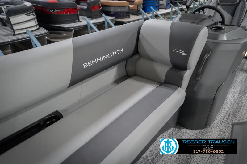Slide: The Image of 2026 Bennington 22 SSB boat interior with gray seating and console, displayed at Reeder-Trausch Marine. - 42