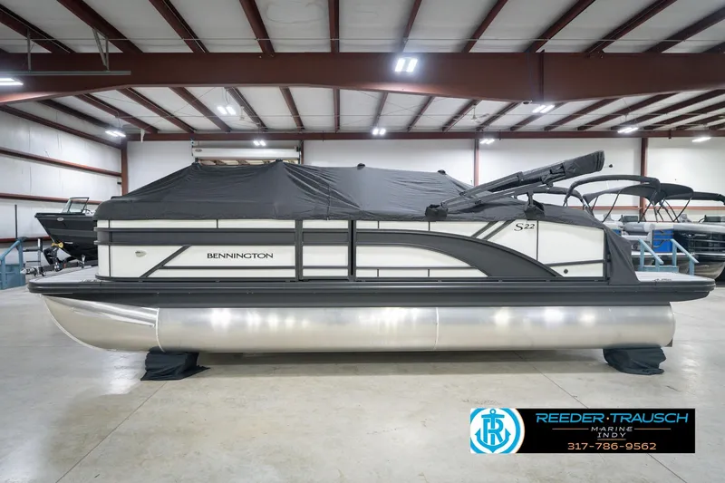 Slide: The Image of 2026 Bennington 22 SSB pontoon boat in showroom, covered and ready for display. - 59
