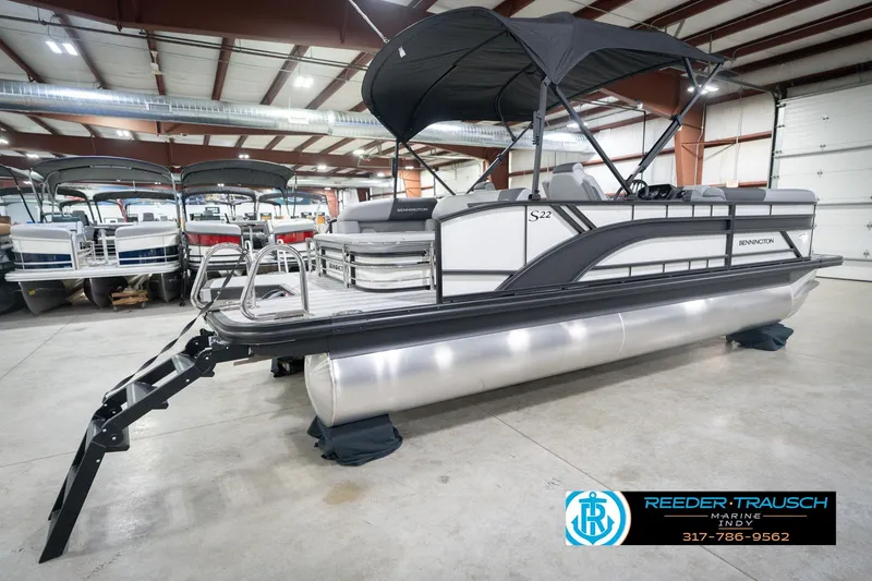 Slide: The Image of 2026 Bennington 22 SSB pontoon boat in showroom with canopy and sleek design. - 8