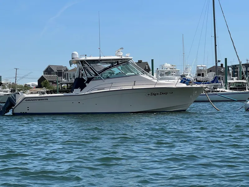 The Image of 2006 Grady-White Express 360 boat docked in a marina, surrounded by water and other vessels. - 1
