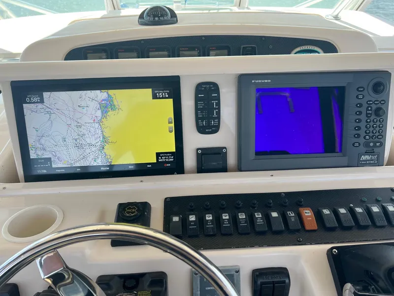 Slide: The Image of Control panel of a 2006 Grady-White Express 360 boat with navigation screens. - 12