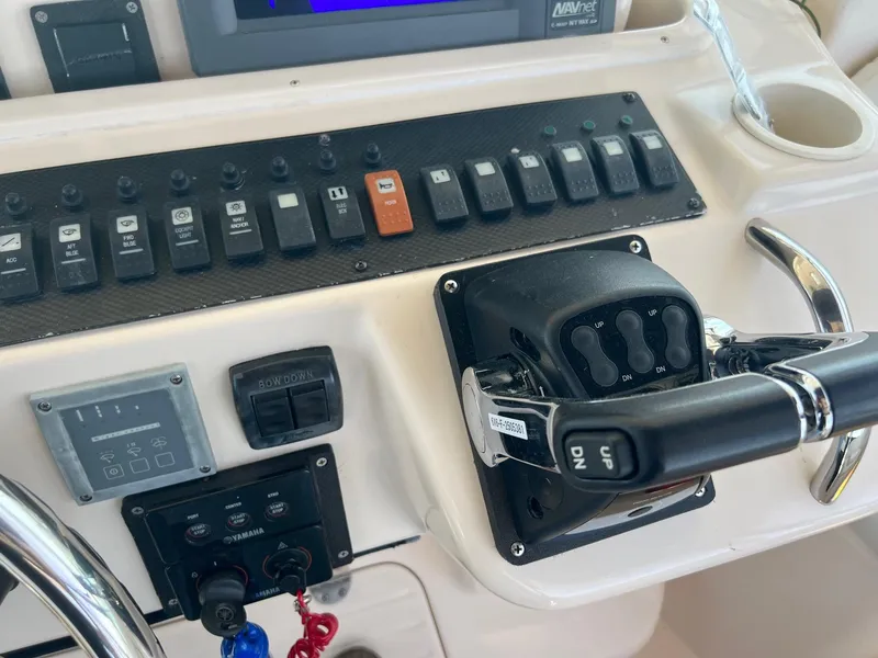 Slide: The Image of Control panel of a 2006 Grady-White Express 360 boat with switches and throttle. - 13