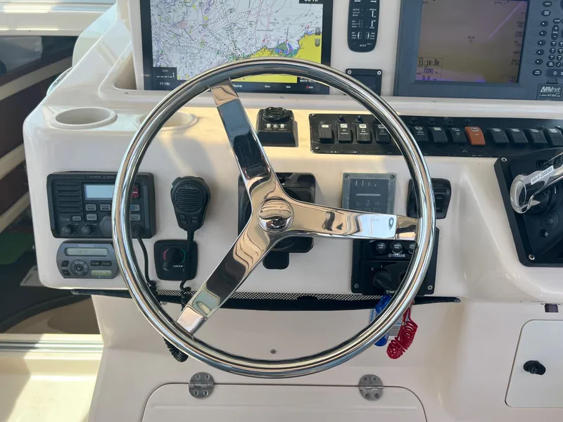 Slide: The Image of Steering wheel and controls of 2006 Grady-White Express 360 boat cockpit. - 14