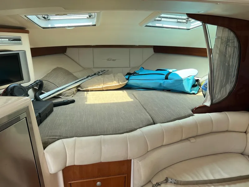 Slide: The Image of 2006 Grady-White Express 360 cabin interior with bed, fishing gear, and storage. - 16