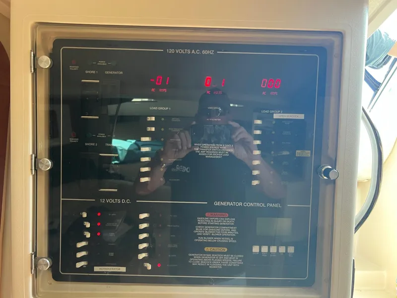 Slide: The Image of Control panel of a 2006 Grady-White Express 360 boat, showing voltage and generator settings. - 19