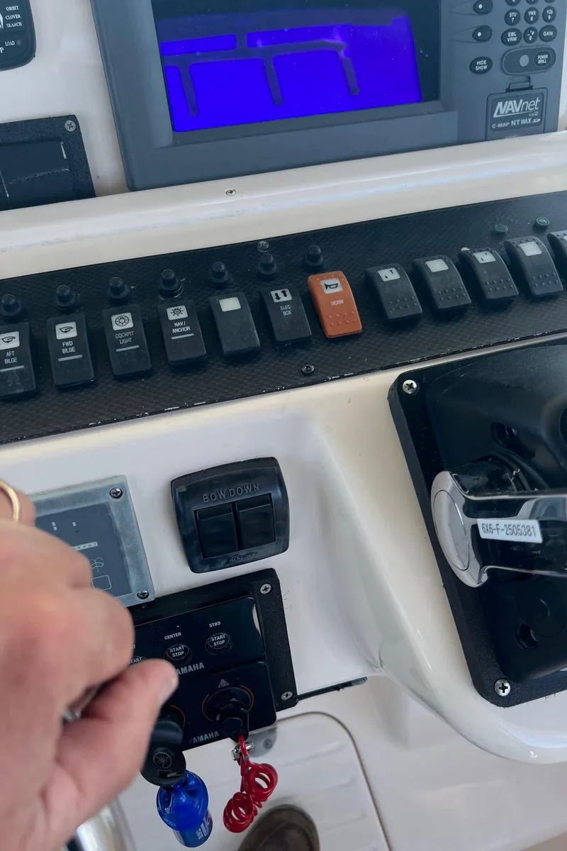 Slide: The Image of Control panel of a 2006 Grady-White Express 360 boat with various switches and displays. - 23