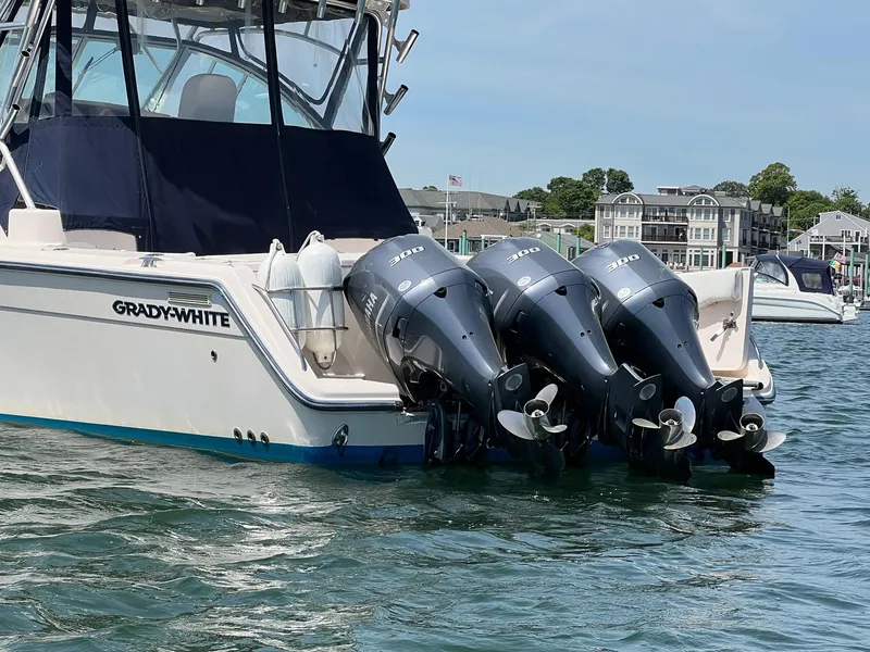 Slide: The Image of 2006 Grady-White Express 360 boat with triple outboard engines on water. - 5