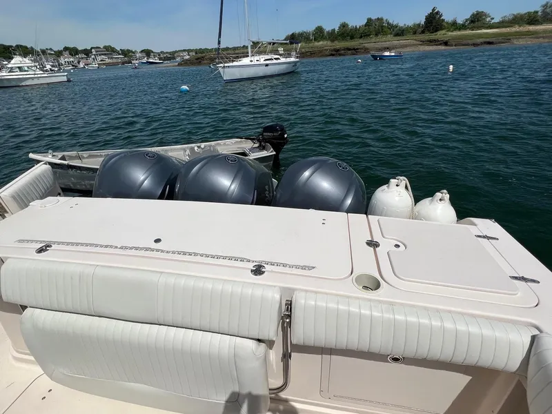 Slide: The Image of 2006 Grady-White Express 360 boat with triple engines, docked in a scenic harbor. - 7