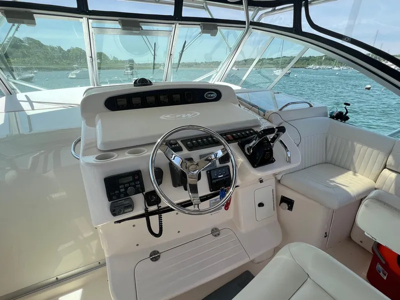 Slide: The Image of 2006 Grady-White Express 360 helm with steering wheel and controls, overlooking a scenic marina. - 9