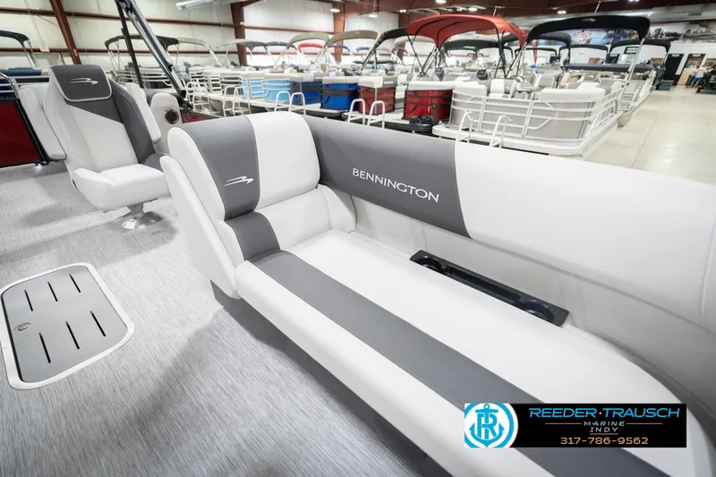 Slide: The Image of 2026 Bennington 22 SSR pontoon boat interior with gray and white seating in showroom. - 21