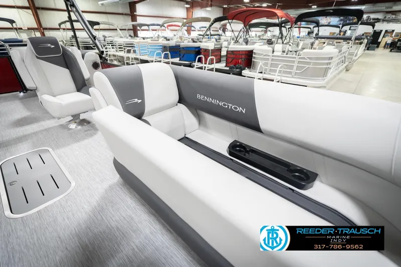 Slide: The Image of 2026 Bennington 22 SSR pontoon boat interior with gray seating in showroom. - 23