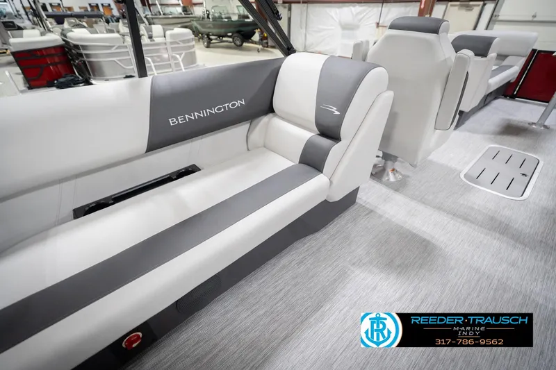 Slide: The Image of 2026 Bennington 22 SSR boat interior with gray and white seating, showroom display. - 26
