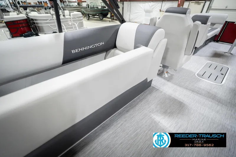 Slide: The Image of 2026 Bennington 22 SSR boat interior with gray and white seating, showroom display. - 28