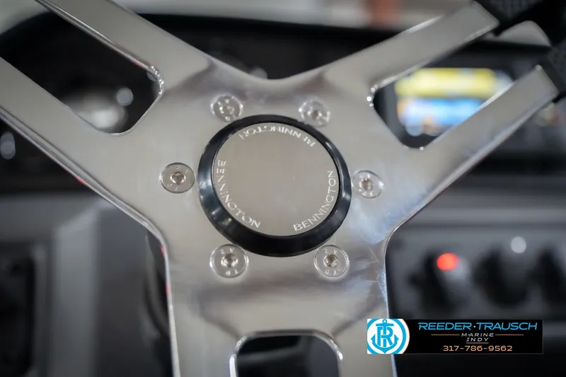 Slide: The Image of Close-up of 2026 Bennington 22 SSR steering wheel with logo and control panel. - 31
