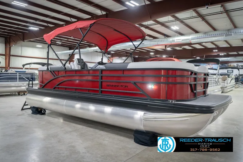 Slide: The Image of 2026 Bennington 22 SSR pontoon boat with red canopy in showroom. - 4
