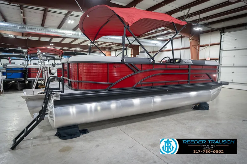 Slide: The Image of 2026 Bennington 22 SSR pontoon boat with red canopy in showroom. - 6