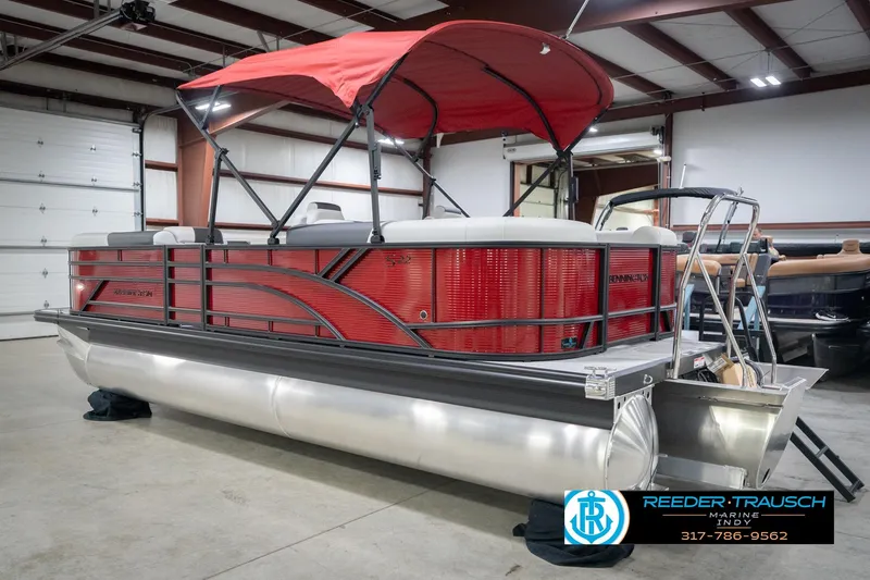 Slide: The Image of 2026 Bennington 22 SSR pontoon boat with red canopy in a showroom. - 8