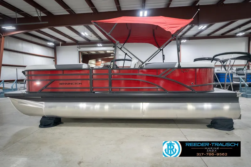 Slide: The Image of 2026 Bennington 22 SSR pontoon boat with red canopy in a showroom. - 9