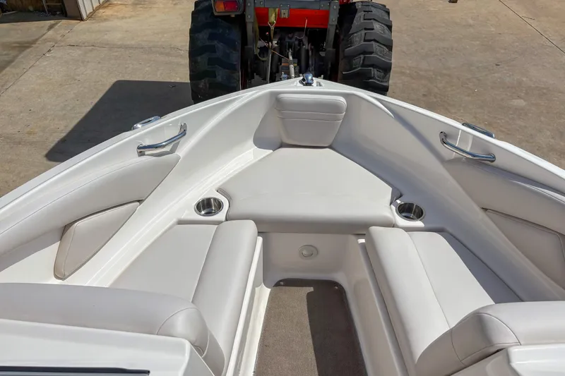 Slide: The Image of 2008 Regal 1900 Bowrider boat interior with white seating and cup holders. - 8