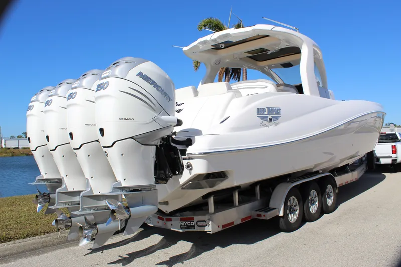 Slide: The Image of 2019 Deep Impact 399 Sport boat with four powerful engines on a trailer. - 15