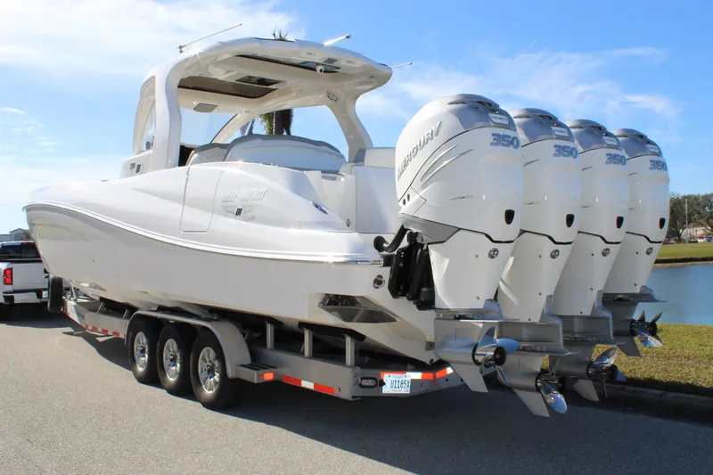 Slide: The Image of 2019 Deep Impact 399 Sport boat on trailer with four powerful outboard engines. - 16