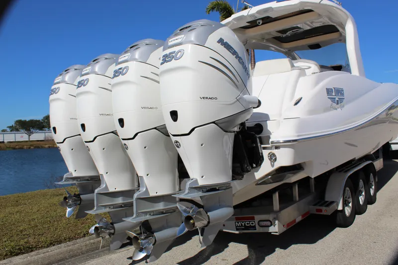 Slide: The Image of 2019 Deep Impact 399 Sport boat with four powerful outboard engines on a trailer. - 17