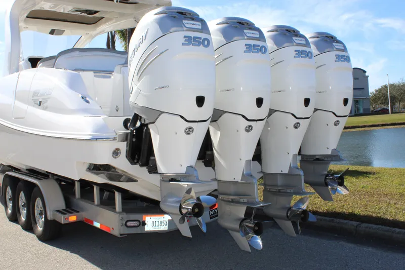 Slide: The Image of 2019 Deep Impact 399 Sport boat with four powerful outboard engines on a trailer. - 18