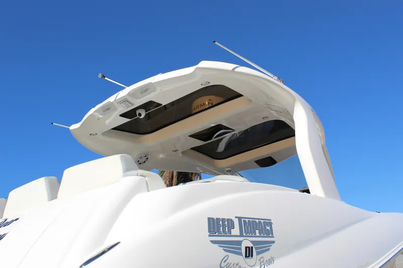 Slide: The Image of 2019 Deep Impact 399 Sport boat, featuring sleek design and modern amenities under a clear blue sky. - 23