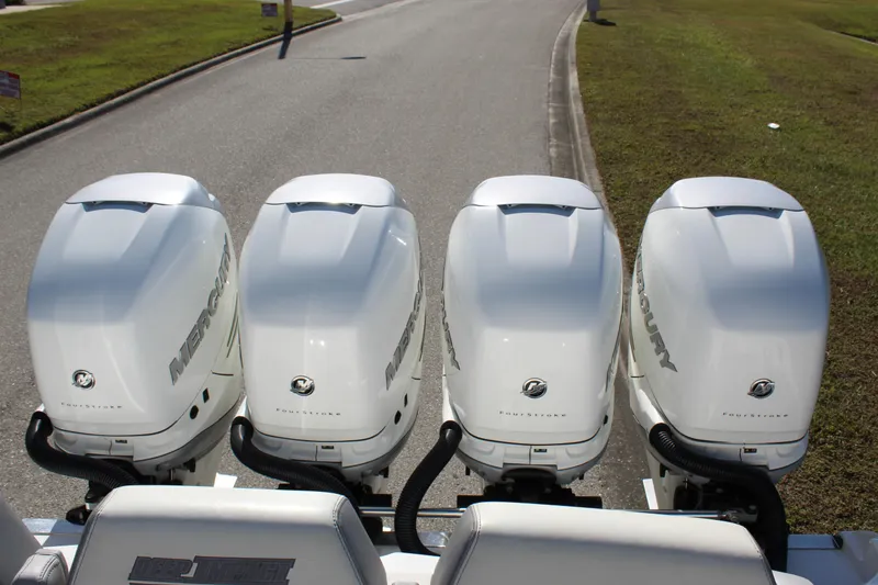 Slide: The Image of Four Mercury outboard engines on a 2019 Deep Impact 399 Sport boat. - 25