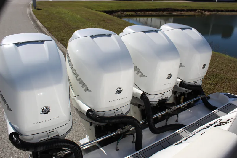Slide: The Image of Four Mercury outboard engines on a 2019 Deep Impact 399 Sport boat. - 26
