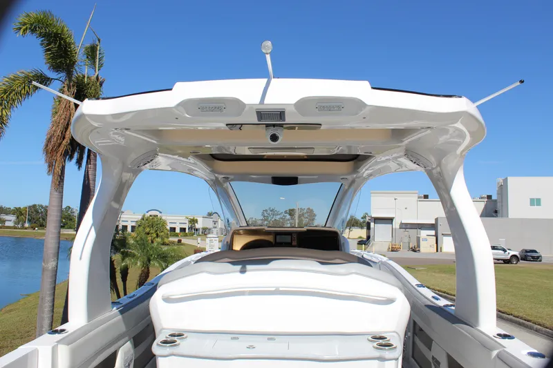 Slide: The Image of 2019 Deep Impact 399 Sport boat, rear view, showcasing sleek design and spacious deck. - 31