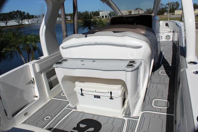 Slide: The Image of 2019 Deep Impact 399 Sport boat interior with seating and cooler. - 32