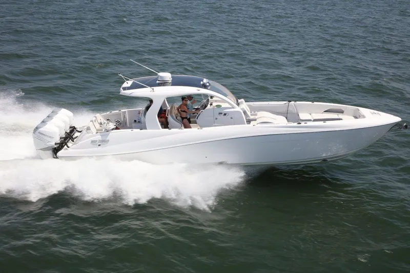 Slide: The Image of 2019 Deep Impact 399 Sport boat cruising on open water. - 78
