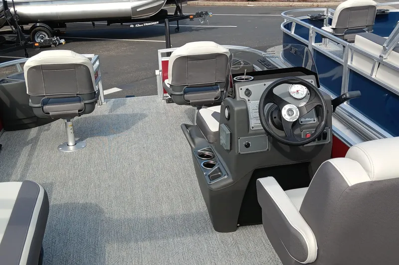 Slide: The Image of 2026 Sun Tracker Bass Buggy 18 DLX interior with steering console and seating. - 3