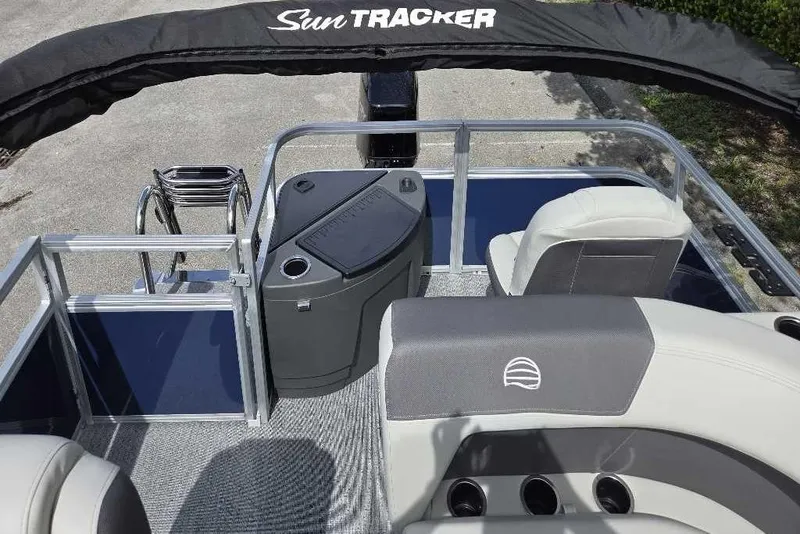 Slide: The Image of 2026 Sun Tracker Bass Buggy 18 DLX interior with seating and console, featuring modern design. - 3