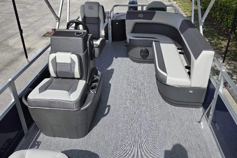 Slide: The Image of 2026 Sun Tracker Bass Buggy 18 DLX pontoon boat interior with seating and steering console. - 4