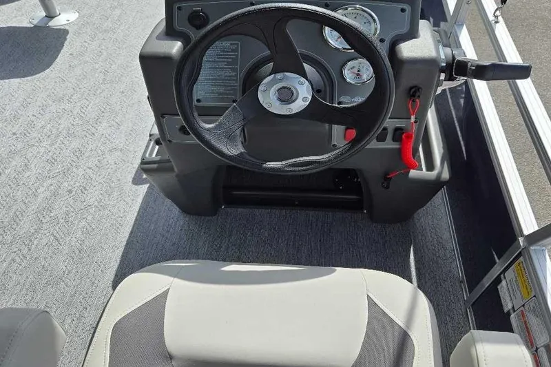 Slide: The Image of 2026 Sun Tracker Bass Buggy 18 DLX steering console with gauges and controls. - 5