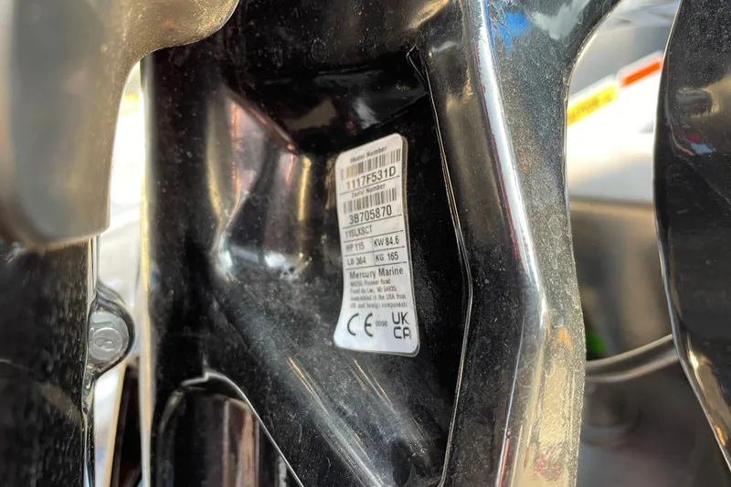 Slide: The Image of Close-up of a 2026 Sun Tracker Fishin' Barge 20 DLX engine label. - 97