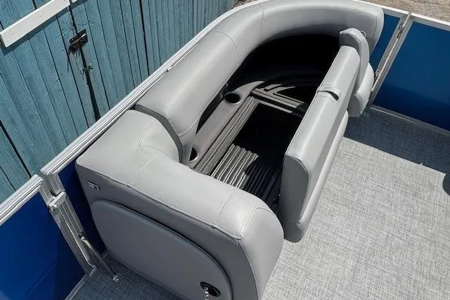 Slide: The Image of 2026 Sun Tracker Party Barge 18 DLX with gray seating and storage compartment. - 11