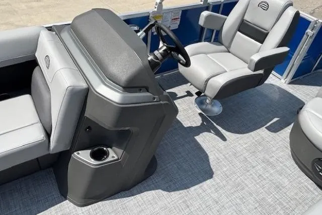 Slide: The Image of 2026 Sun Tracker Party Barge 18 DLX interior with helm and seating area. - 14