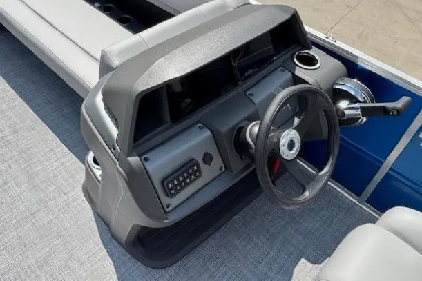 Slide: The Image of 2026 Sun Tracker Party Barge 18 DLX dashboard with steering wheel and controls. - 15