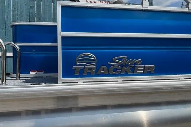Slide: The Image of 2026 Sun Tracker Party Barge 18 DLX pontoon boat with blue exterior and logo. - 5