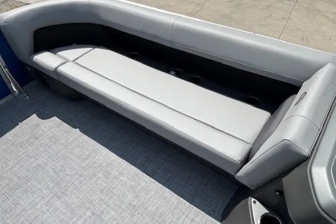 Slide: The Image of 2026 Sun Tracker Party Barge 18 DLX interior with gray seating and flooring. - 8