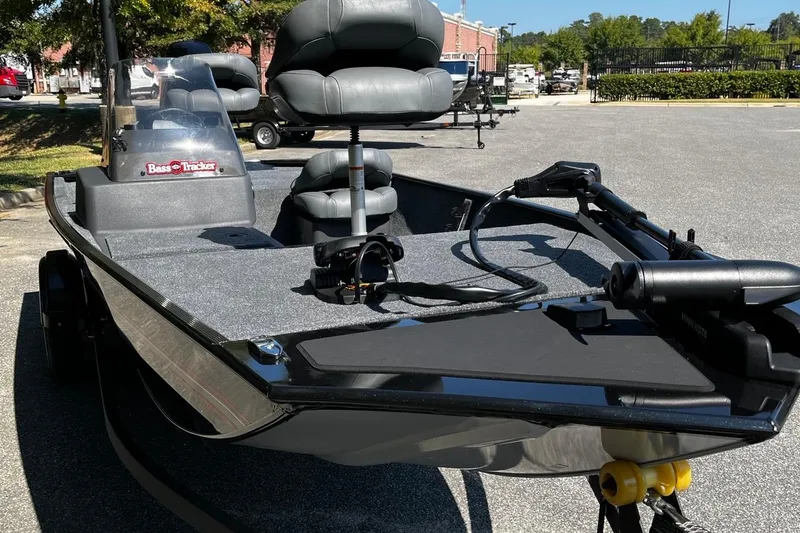 Slide: The Image of 2026 Tracker Bass Tracker Classic XL boat with seating and equipment, parked outdoors. - 7