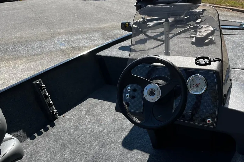 Slide: The Image of 2026 Tracker Bass Tracker Classic XL boat dashboard with steering wheel and gauges. - 8