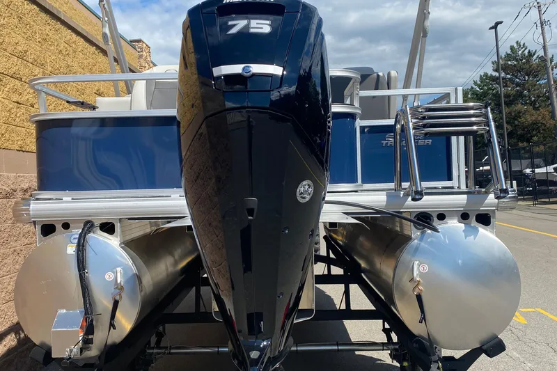 Slide: The Image of 2026 Sun Tracker Bass Buggy 18 DLX pontoon boat with 75 HP engine, docked outdoors. - 4