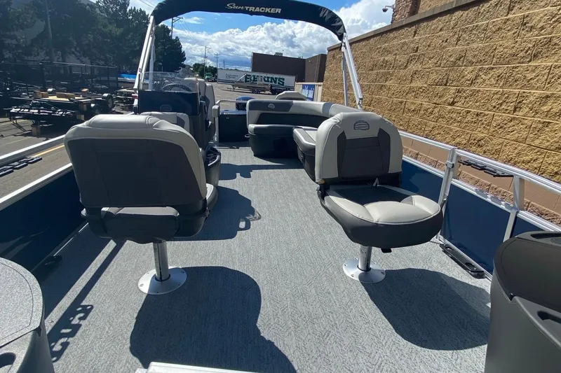 Slide: The Image of 2026 Sun Tracker Bass Buggy 18 DLX pontoon boat interior with seating and open deck. - 5